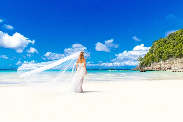 Beautiful blond bride in white wedding dress with big long white — Stock Photo, Image