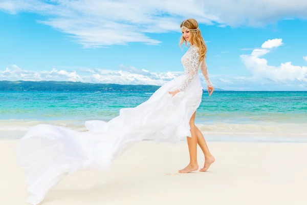 Beautiful blond bride in white wedding dress with big long train — Stock Photo, Image