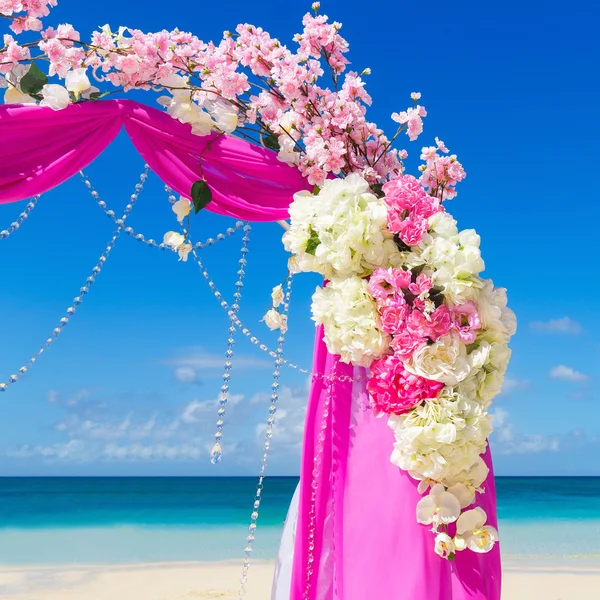 Boda en la playa. Arco de boda en púrpura decorado con flo — Foto de Stock