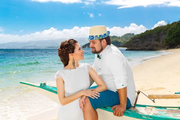 Happy bride and groom having fun on a tropical beach. Wedding and honeymoon on the tropical island. — Stock Photo, Image