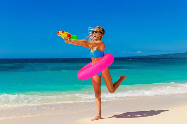 Young beautiful girl in blue bikini having fun on a tropical bea — Stock Photo, Image