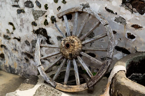 Ancient broken wooden wheel from a horse-drawn carriage