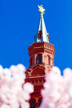 Moskova, Rusya - 9 Nisan 2019: Kremlin Kulesi bahar kiraz çiçeklerinin arka planında. Paskalya bayramları için şehir sokaklarının dekorasyonu..