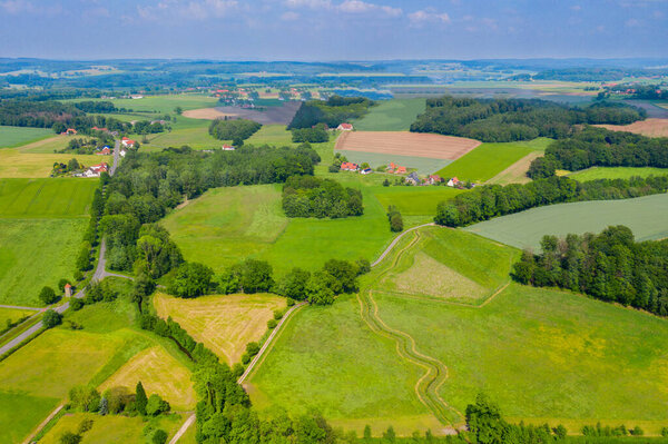 Aerial view from the drone of landscape of the German countryside. Agricultural fields, villages, and woodlands.