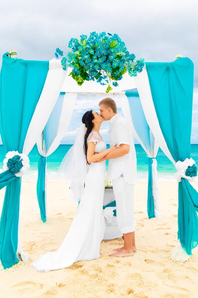 Svatební obřad na tropické pláži v modrém. Šťastný ženich a br — Stock fotografie