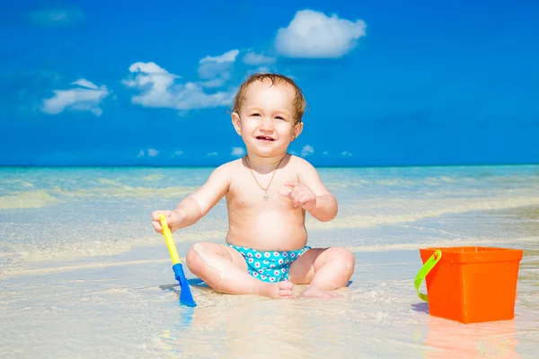 Un niño divirtiéndose en una playa tropical. Con vacaciones de verano —  Fotos de Stock