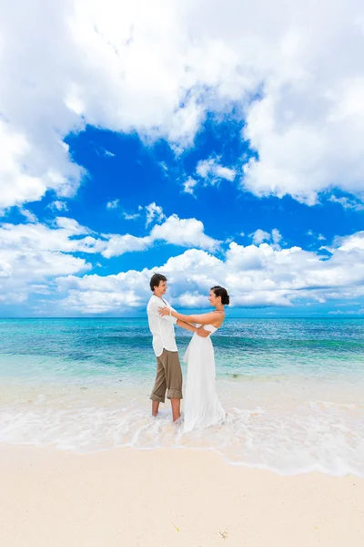 Happy groom and bride having fun on the sandy tropical beach. We — Stock Photo, Image