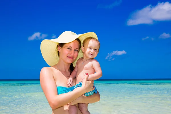Happy family, mom and little child having fun on a tropical beac Stock Image