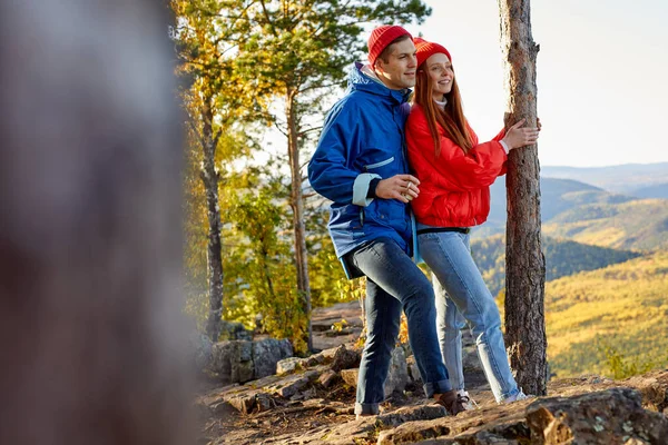 Romantic fit couple stand in contemplation of autumn mountains — Stock Photo, Image