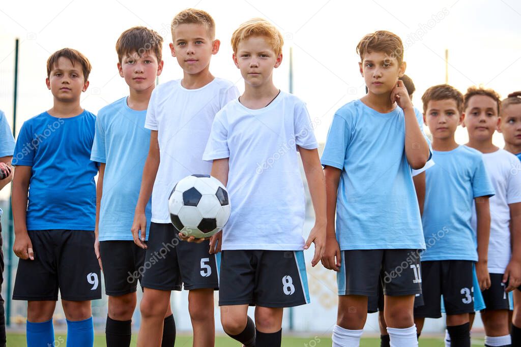 portrait of sportive boys with ball