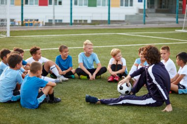 Genç sporcu çocuklar futbol müsabakası sırasında ara veriyor.