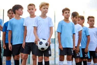portrait of confident team of young football players clipart