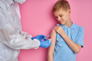 Cesur çocuk, takım elbiseli doktor tarafından iğnelendi.