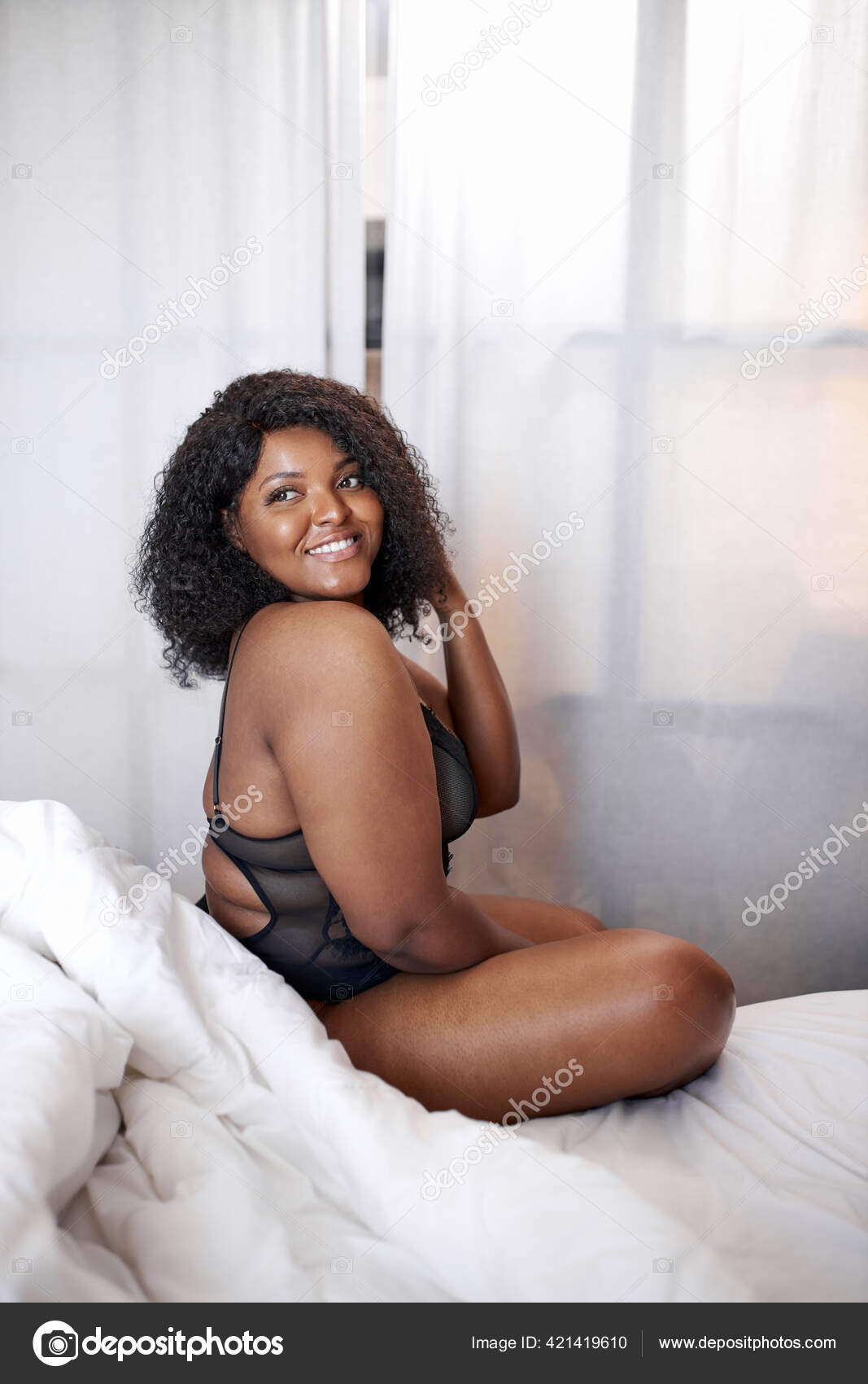 Plump african woman in lingerie sits on bed in the morning Stock Photo by ©romanchazov27 421419610 pic