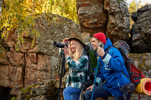 enthusiastic happy tourists on mountains or rocks