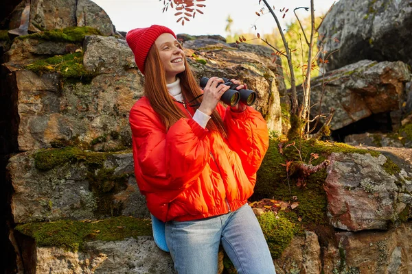 Redhead caucasian female is using binoculars for better contemplation of nature around — Stock Photo, Image