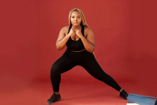 portrait of confident oversize woman standing in fighting pose