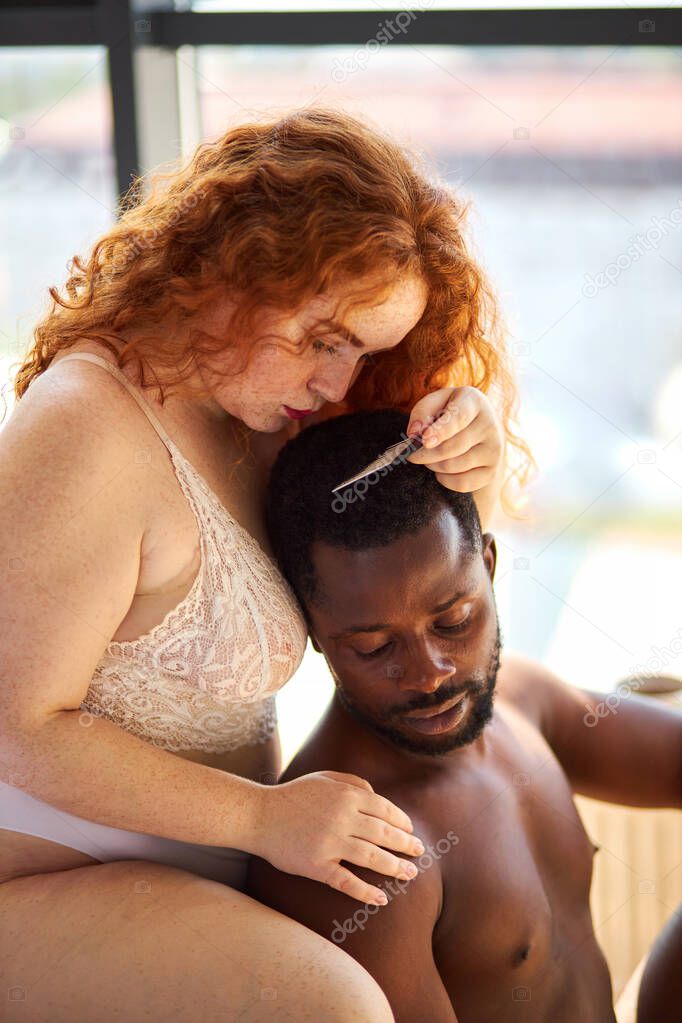 multiracial couple in love at home, sensual man and woman