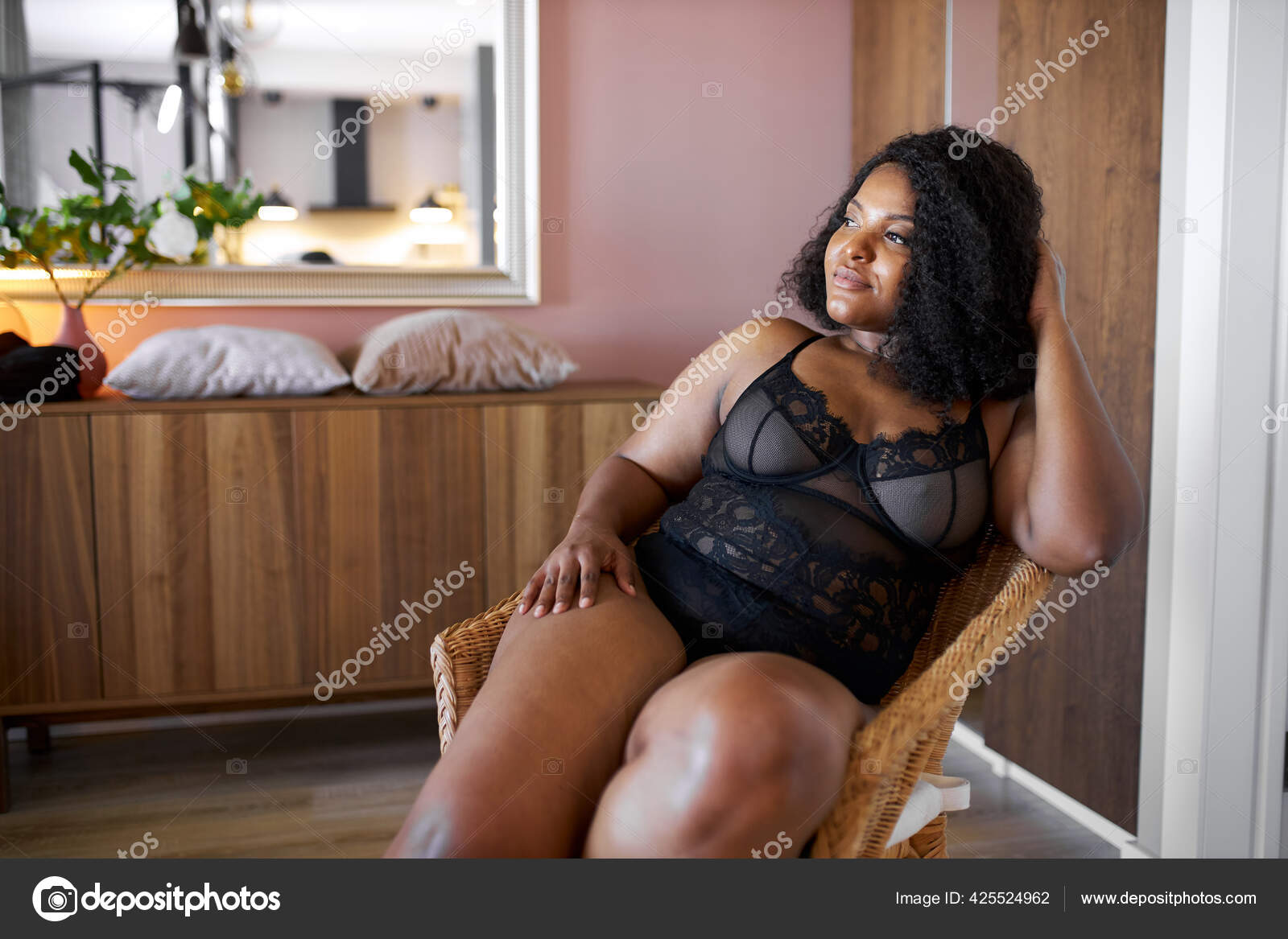 Good-looking african woman with half naked plus size body sits on armchair  Stock Photo by ©romanchazov27 425524962