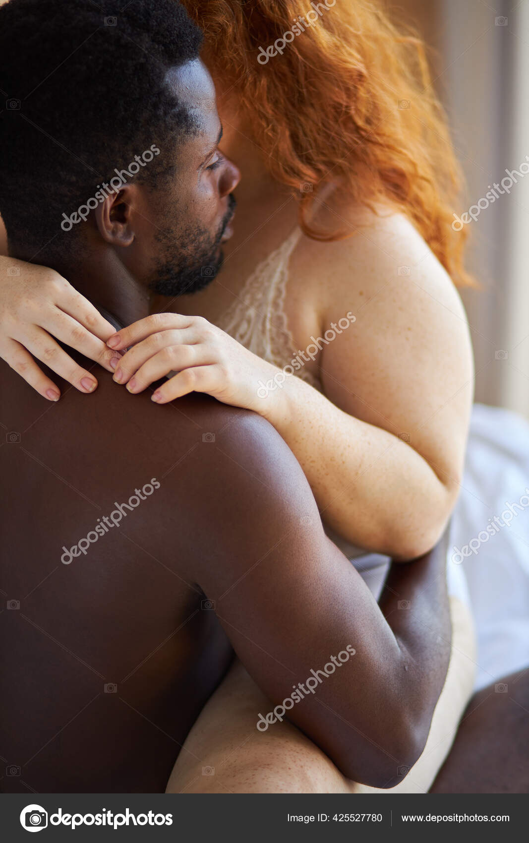 Passion between tender interracial diverse man and woman at home Stock Photo by ©romanchazov27 425527780
