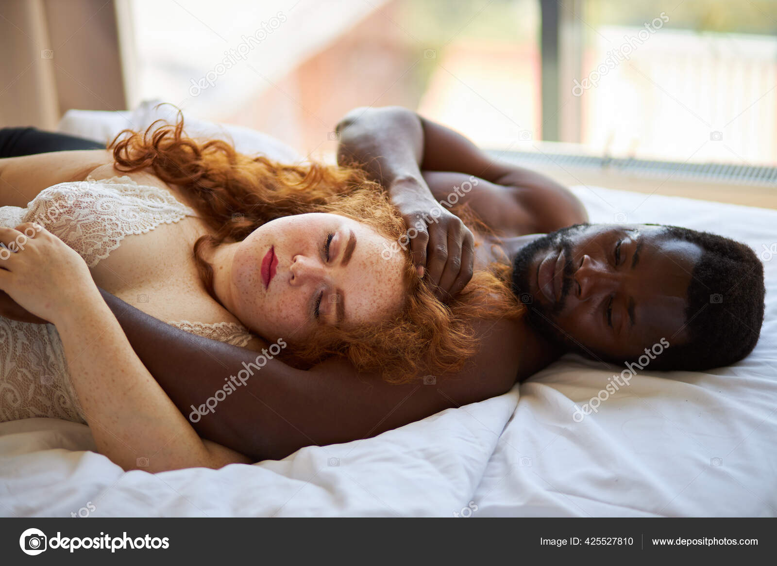 Beautiful interracial couple sleeping together on bed Stock Photo by ©romanchazov27 425527810 image