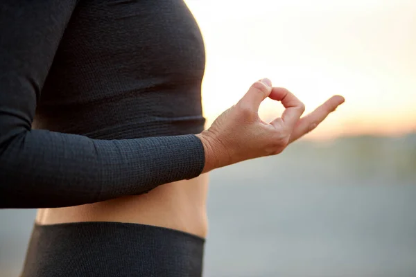 woman practicing yoga, close-up photo of hands make a namaste , keep calm and do yoga