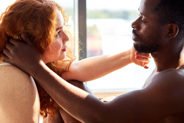Passion between tender interracial diverse man and woman at home — Stock Photo, Image