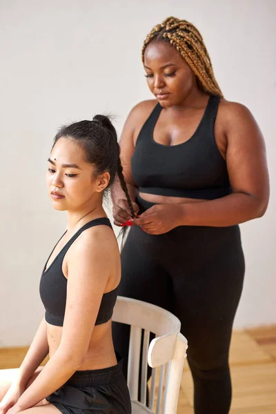friendly diverse women preparing for fitness exercises