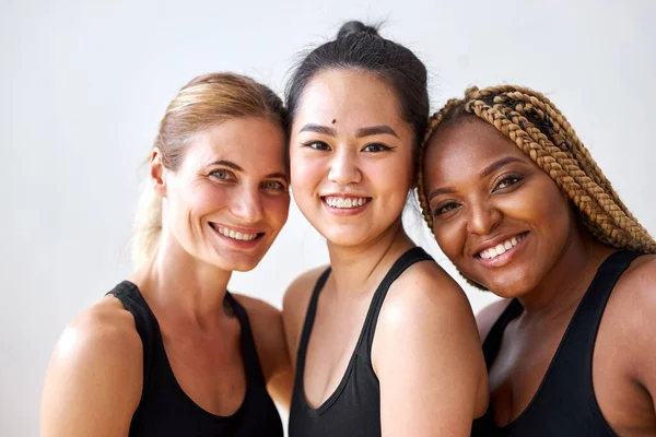 Positive cheerful mixed race women posing, smiling at camera — Stock Photo, Image