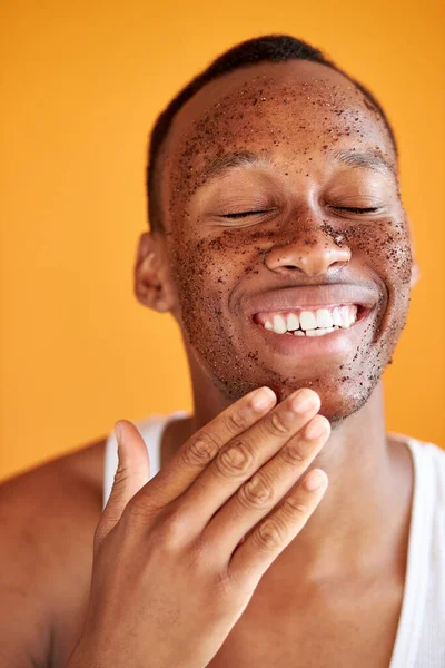 Afrikai ember alkalmazza bozót az arcon elszigetelt narancssárga háttér — Stock Fotó