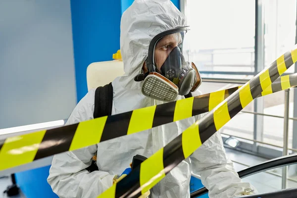 Portrait of disinfectant male in suit and mask working in closed territory — Stock Photo, Image