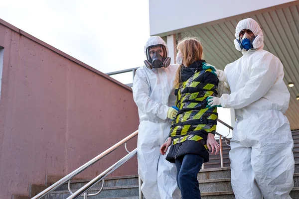 Equipo de desinfectantes profesionales nota mujer infectada en la construcción —  Fotos de Stock
