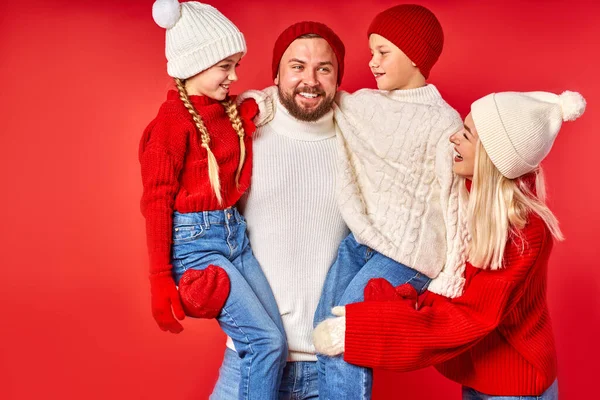 portrait of happy family in winter clothes