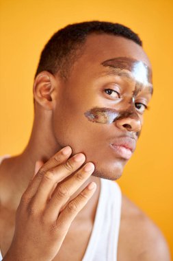 T Bölgesi 'nde maske takan kendinden emin Afro-Amerikan bir adamın portresi.