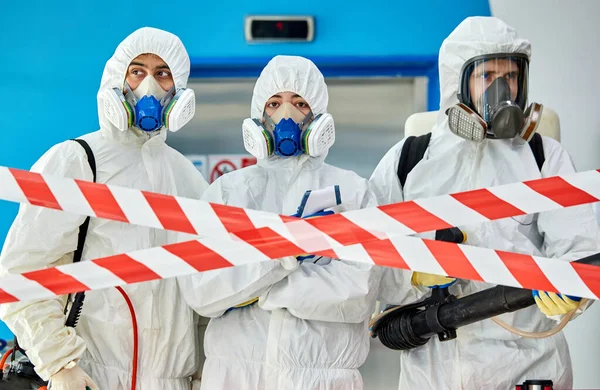 Disinfectors stopping the entrance into the building — Stock Photo, Image