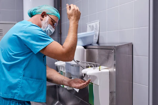 male doctor washing hands after or before operation