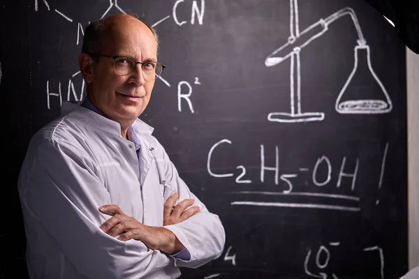 portrait of confident chemist professor posing at camera