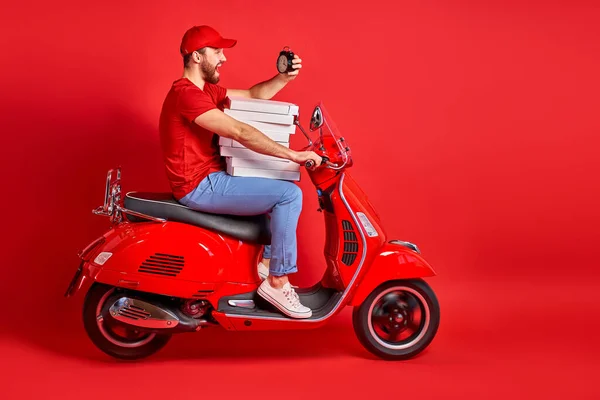 handsome courier guy on motorbike is hurry to deliver orders