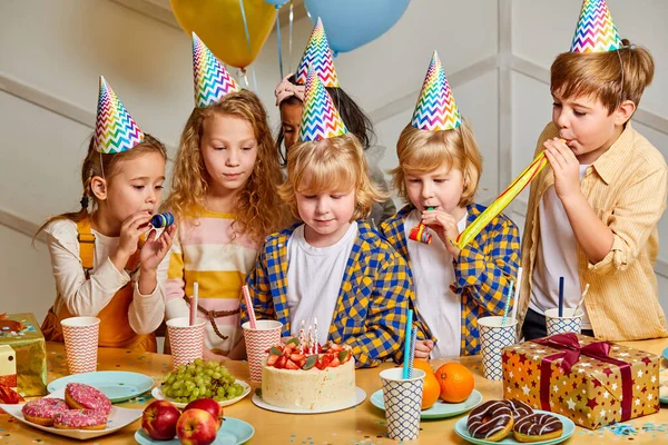 birthday party. children in party caps celebrating birthday