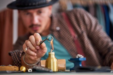 Yakından bakınca kuyumcu mücevher yüzüklerini lehimliyor.