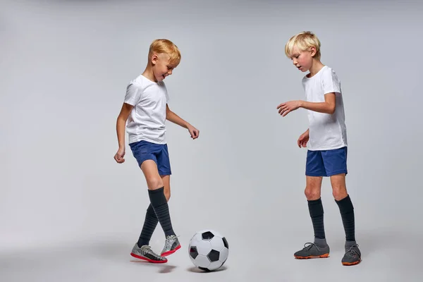 Dois meninos ativos caucasianos jogar futebol ou futebol — Fotografia de Stock