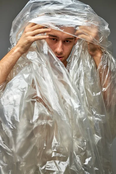 young man with plastic bags on body