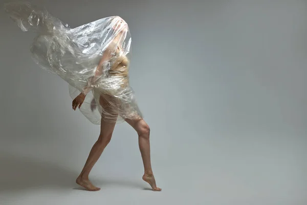 Retrato de cuerpo entero de mujer delgada semidesnuda posando con bolsa de plástico transparente —  Fotos de Stock