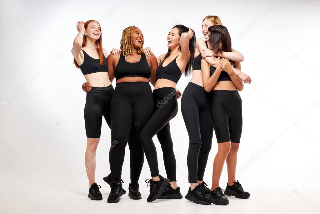 young attractive women, mixed race group of models posing, laughing