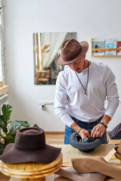 male hats maker shape the hat in workshop