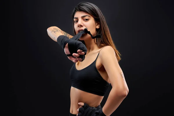 М'язова сильна жінка одягає рукавички для боксу — стокове фото