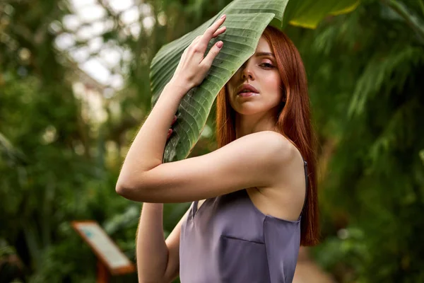 Retrato da bela mulher caucasiana em pé sobre palmeiras, caminhando em resort tropical — Fotografia de Stock