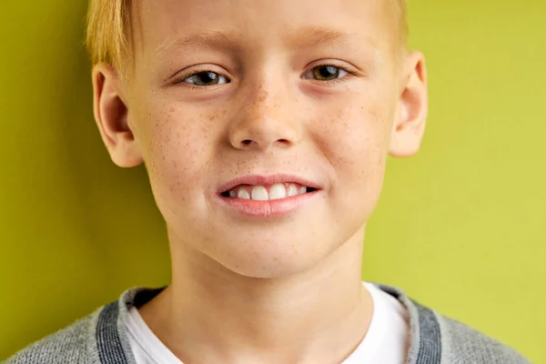 Glimlachen Kaukasische schooljongen kijken naar camera geïsoleerd op groen — Stockfoto