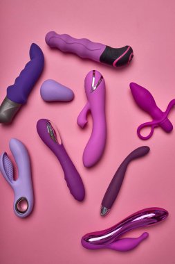 Colourful Dildo, vibrator in sex shop assortment. toys for adults, sensuality, excitement concept.