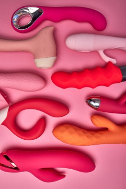 Flat lay red and pink cute dildo smooth vibrators